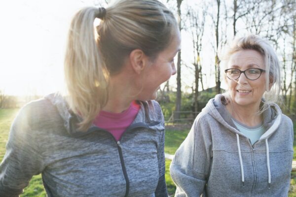 Women Wearing Sports Clothing Face To Face Talking